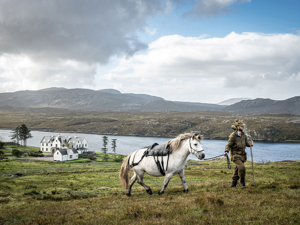 Man walking in nature with pony