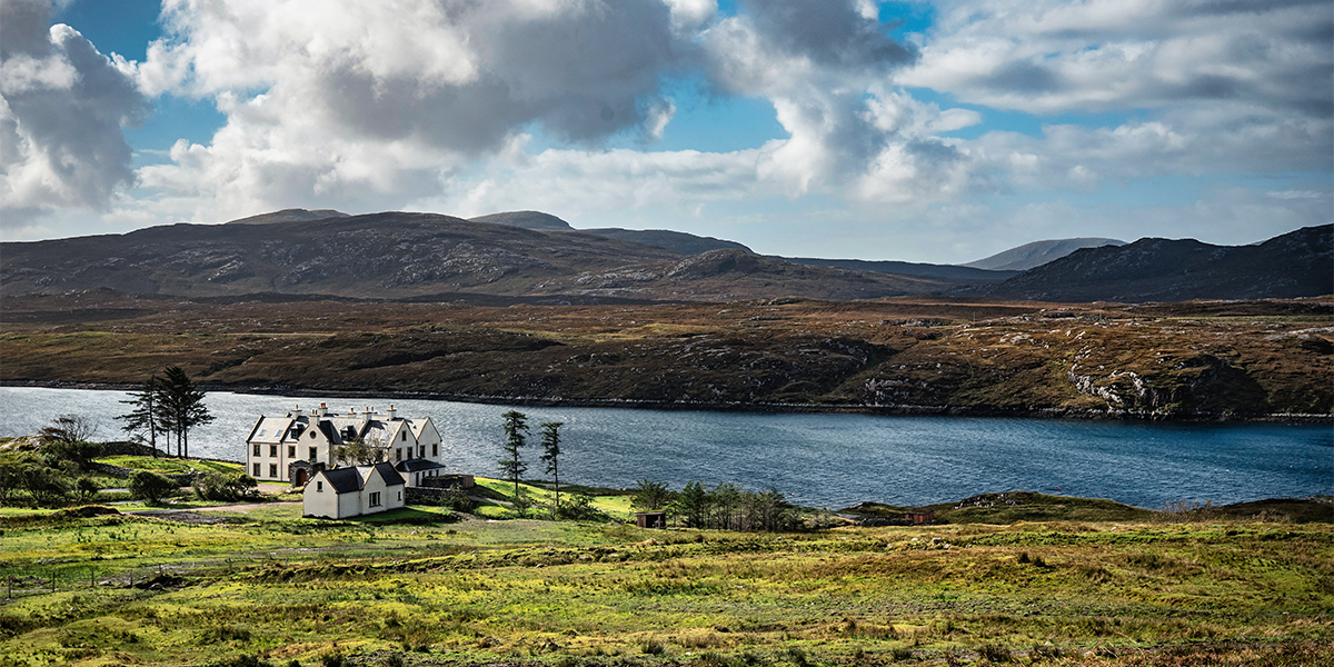 Panoramic view of SCALISCRO estate surrounded by loch and rugged Isle of Lewis landscape